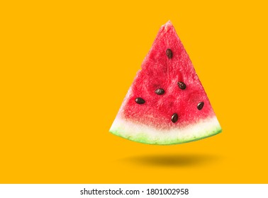 Watermelon triangular slice isolated on orange background
