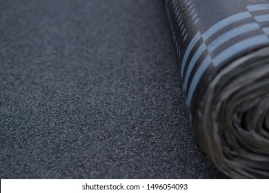 Waterproof bitumen roll covered with insulation materials, abstract background, closeup texture.