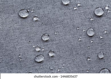 Waterproof droplets on fabric. Grey Canvas Polyester texture synthetical for background. Black polyester textile backdrop for interior art design or add text message.