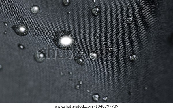 Waterproof fabric, clothing\
with water drops. Rain drops on water resistant textile waterproof\
coating