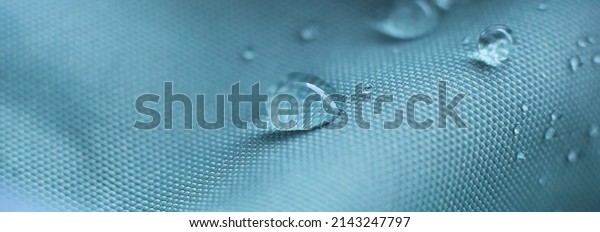 waterproof fabric with waterdrops. non woven fabric\
water texture background Water drops on waterproof nylon fabric.\
soft focus