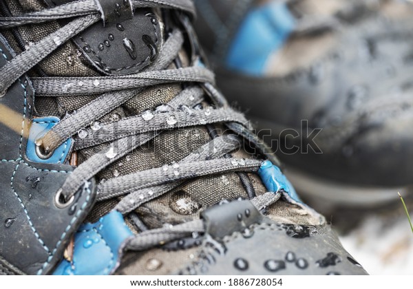 waterproof hiking boots. closeup of footwear with\
rain water drops