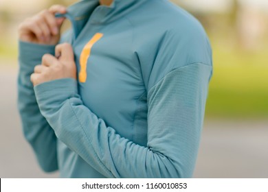 Waterproof windbreaker. Jacket for running. Girl in sports clothes