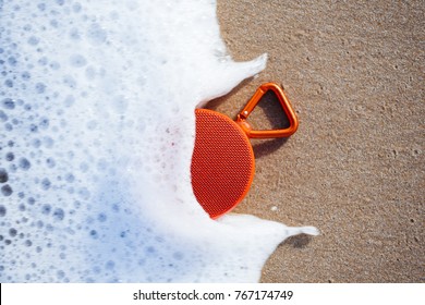 Waterproof Wireless Speaker On The Beach Wet By The Waves