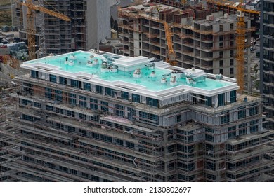 Waterproofing coating on high skyscraper rooftop. Elastomeric liquid-applied membranes and field tests of waterproofing. Roof protection system, reinforcing net. Ponding test.