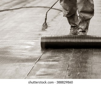 Waterproofing Roll Bituminous Material In The Trench. Construction Worker Manufacturer Uses A Gas Burner Propane Tank Fire.