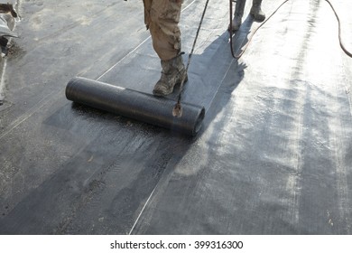 Waterproofing Roll Bituminous Material In The Trench. Construction Worker Manufacturer Uses A Gas Burner Propane Tank Fire.