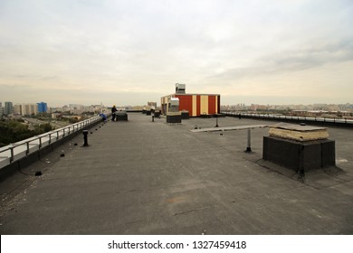 Waterproofing The Roof Of Residential Building. Covering Roofing Material. Flat Roof With Roofing And Fencing. 