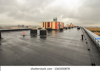 Waterproofing The Roof Of Residential Building. Covering Roofing Material. Flat Roof With Roofing And Fencing.