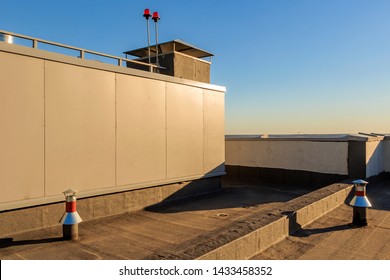 Waterproofing Roof Of Residential Building. Covering Roofing Material. Flat Roof With Roofing And Fencing. Roof Of Modern Monolithic High-rise Building. Blue Sky