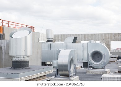 Waterproofing The Roof Of Residential Building With Industrial Steel Air Conditioning And Ventilation Systems. Covering Roofing Material. Flat Roof With Roofing And Fencing.