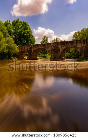 Waterreflections on the River under an old Bridge. Summerdays at the River. Cloudreflections at the River.