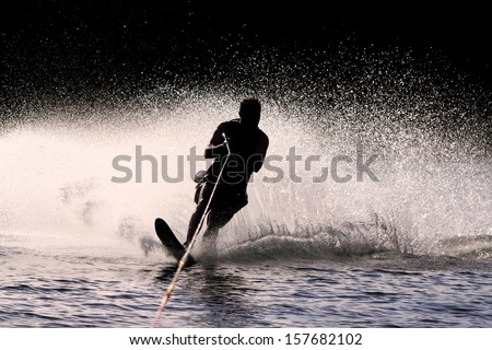 Waterskier silhouette with glowing spray