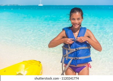 Watersport fun on Caribbean summer beach vacation. Woman tourist going on kayak tour activity on ocean, wearing life jacket. - Powered by Shutterstock