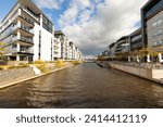 Waterways for recreational boating, framed by residential units in Kingston Foreshore ACT. The receding lines create a feeling of contained depth in the scene.