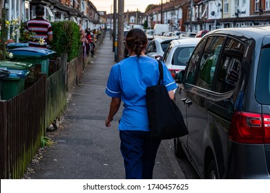 WATFORD, HERTFORDSHIRE, UK - MAY 21 2020: A Nurse Returns From Her Shift At Watford General Hospital As Local Residents Clap Their Hands And Make A Noise For Carers And Key Workers. 