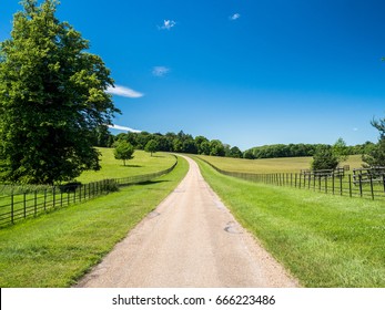 Watling Street, a Roman road in Great Britain, stretching to the horizon between green fields under a clear blue sky.