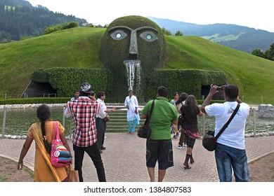 Wattens, Tyrol/ Austria - July 22 2010: Tourists Looking At The Giant, A Fountain Created  By Austrian Artist André Heller, Located At The Entrance To The Swarovski Crystal Worlds 