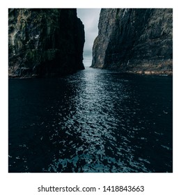 Watter between the high cliffs of Faroe Islands.