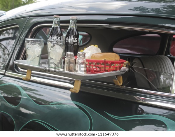 WAUPACA, WI - AUGUST 25: Drive thu tray on\
1949 Mercury Coupe car with burger, coca cola, and fries at the\
10th Annual Waupaca Rod & Classic Car Club Car Show on August\
25, 2012 in Waupaca,\
Wisconsin.
