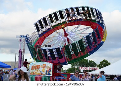 Waupun, Wisconsin USA - June 25th, 2019: Family And Young Adults Ride On Zero Gravity Carnival Ride At Celebrating Waupun Fair.  