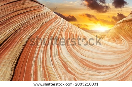 The Wave is an awesome vivid swirling petrified dune sandstone formation in Coyote Buttes North. It could be seen in Paria Canyon-Vermilion Cliffs Wilderness, Arizona. USA. Sunset time