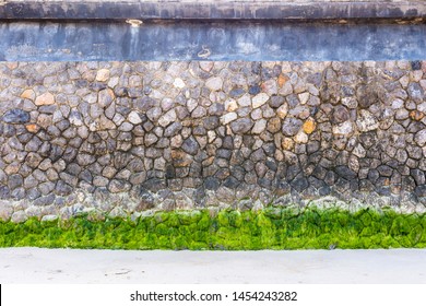 A Wave Barrier From The Sea, Natural Stone Wall With Lemongrass Is Located On The Beautiful White Sand Beach Of Hua Hin, Thailand.