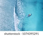 Wave and boat on the beach as a background. Beautiful natural background at the summer time from air