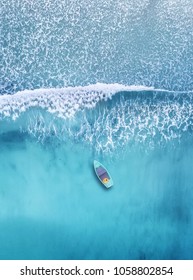 Wave and boat on the beach as a background. Beautiful natural background at the summer time from air - Shutterstock ID 1058802854