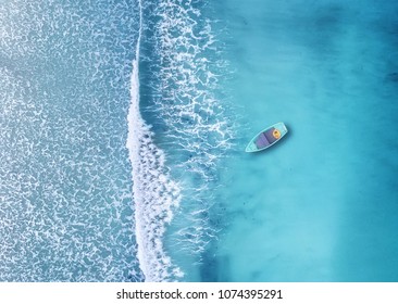 Wave and boat on the beach as a background. Beautiful natural background at the summer time from air - Shutterstock ID 1074395291