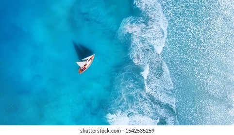 Wave and boat on the beach as a background. Beach and waves from top view. Turquoise water background from top view. Top view from drone. Travel - image