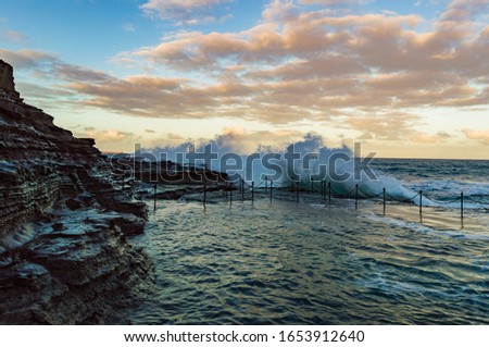 A wave breaking on the Bogey Hole in Newcastle Australia. This convict created swimming hole is popular place to cool off in Newcastle, Australia.