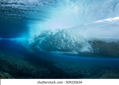 A wave breaking underwater. - Powered by Shutterstock