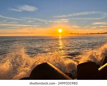 Wave crash against rocks with sunset  - Powered by Shutterstock