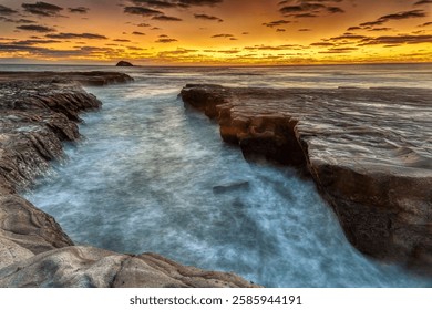 Wave cut platform below Muriwai's famous Gannet Colony. Looking out to the west with a sunset after glow