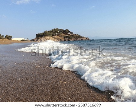 a wave hits the beach