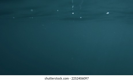 Wave on moving water surface close up in the middle of the screen.  Under Water Surface in the middle of the sea - Shutterstock ID 2252406097