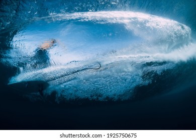 Wave with surfer under water. Surfer ride on wave, view from underwater