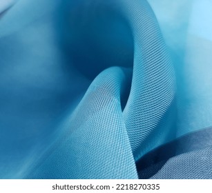 Wave turquoise blue transparent fabric;
two twisted folds (macro, texture).
 - Shutterstock ID 2218270335