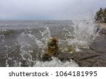 wave of water splash over the rocky shore and inukshuk at the hecla provincial park in manitoba