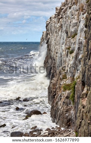 Waves beating against the cliff by the Jons Kapel (John's Chapel), Bornholm island, Denmark.