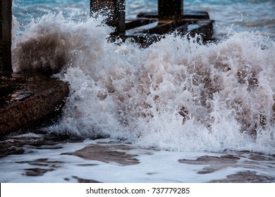 waves beating against the pier