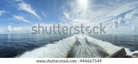 Waves behind the boat, beautifully colored sky over the sea in Cape Coral. Florida