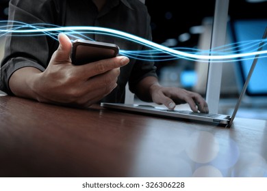 Waves Of Blue Light And Businessman Using On Smart Phone And Laptop Computer As Concept