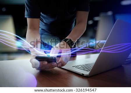 Waves of blue light and businessman using on smart phone as concept