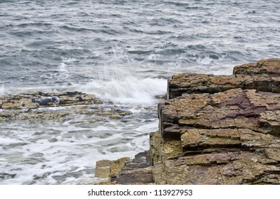 Waves Breaking On Layered Permian Sedimentary Rocks, Fossil Cove,  Tasmania, Australia