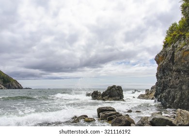 Waves breaking on the rocks .