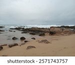 Waves breaking on rocks at Rocky beach in Park Rynie. Seaside holiday at KwaZulu Natal South Coast, South Africa in April (Autumn) 2024