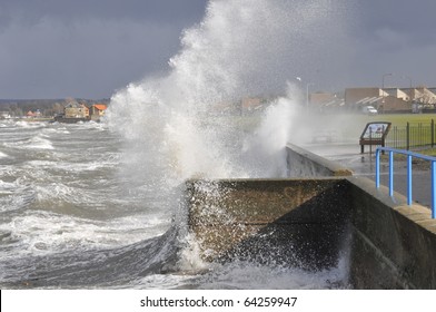 Waves breaking over sea wall 2