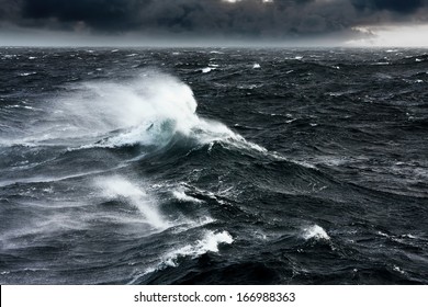 Waves Breaking and Spraying at High Seas and Strong Winds - Shutterstock ID 166988363